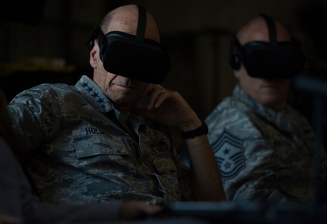 U.S. Air Force Gen. Mike Holmes, commander of Air Combat Command, and Chief Master Sgt. Frank Batten, command chief of Air Combat Command, use virtual reality technology during a visit to the 363rd Intelligence Surveillance Reconnaissance Wing at Joint Base Langley-Eustis, Virginia, Sept. 5, 2018. Through innovation, the 363rd ISRW uses its analytical capabilities and targeting expertise, to pull meaningful patterns from collected intelligence data to produce made-to-order targeting products for operational and tactical-level warfighters. (U.S. Air Force photo by Staff Sgt. Areca T. Bell)