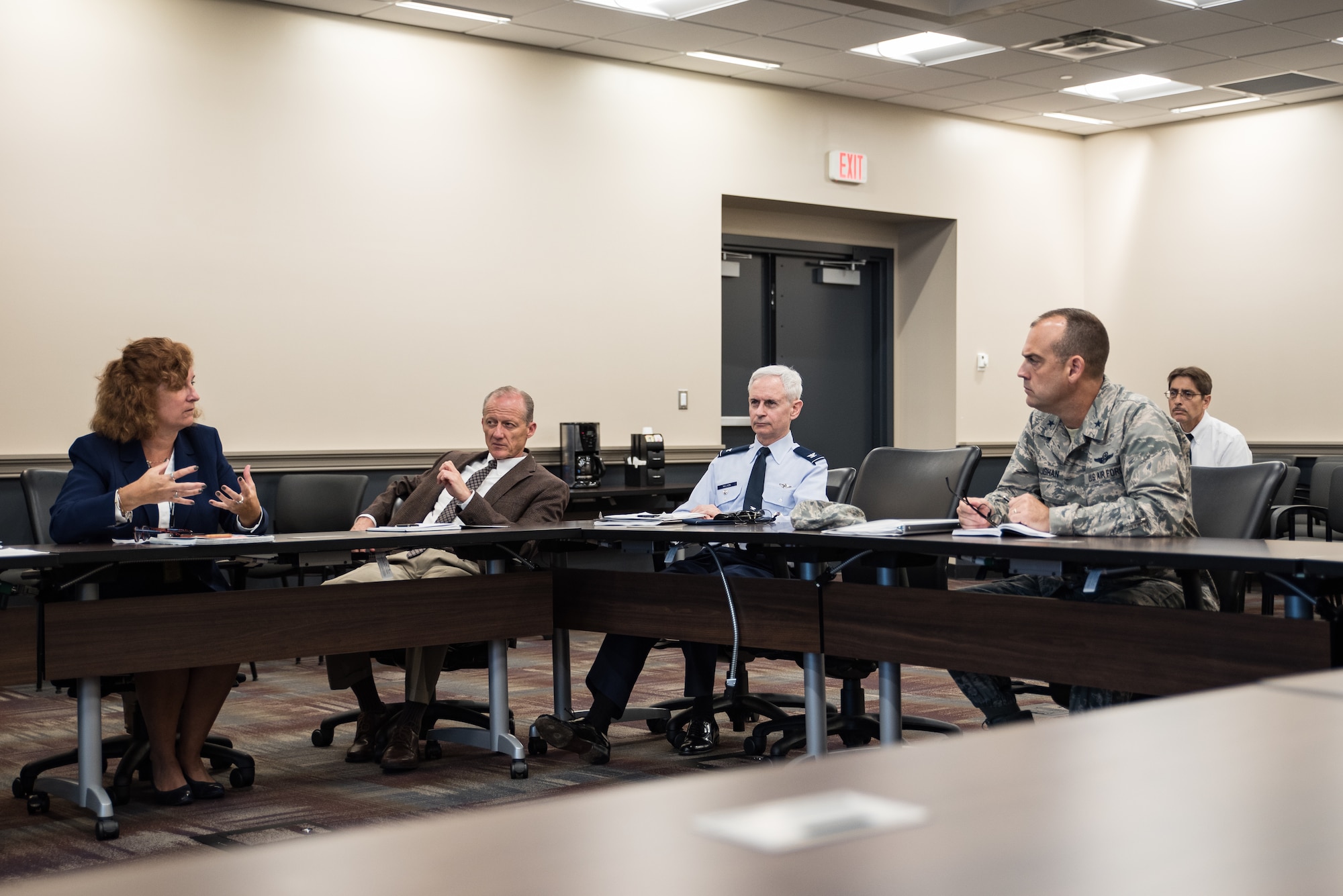 Brig. Gen. Edward L. Vaughan (far right), the Air Force Unexplained Physiological Events Integration Team lead, listens to Jennie Farrell, chief engineer for the Human Systems Division of the Agile Combat Support Directorate of Air Force Life Cycle Management Systems. Also pictured are Patrick Bolibrzuch, deputy program manager for the Training Aircraft Division of AFLCMC; and Col. William Nelson, chief of Integrated and International Operational Medicine in the 711th Human Performance Wing. (U.S. Air Force photo by Richard Eldridge)