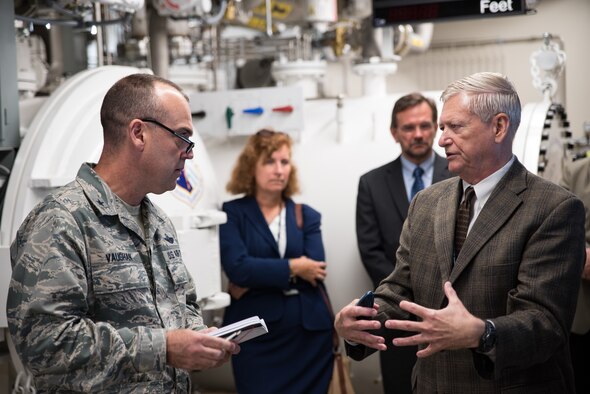 Brig. Gen. Edward L. Vaughan, the Air Force Unexplained Physiological Events Integration Team lead, listens to George Miller, Principal Research engineer with the 711th Human Performance Wing, as he discusses the On- Board Oxygen Generation Systems (OBOGS) laboratory and the research his team is accomplishing during a tour Aug. 27 at Wright-Patterson Air Force Base.