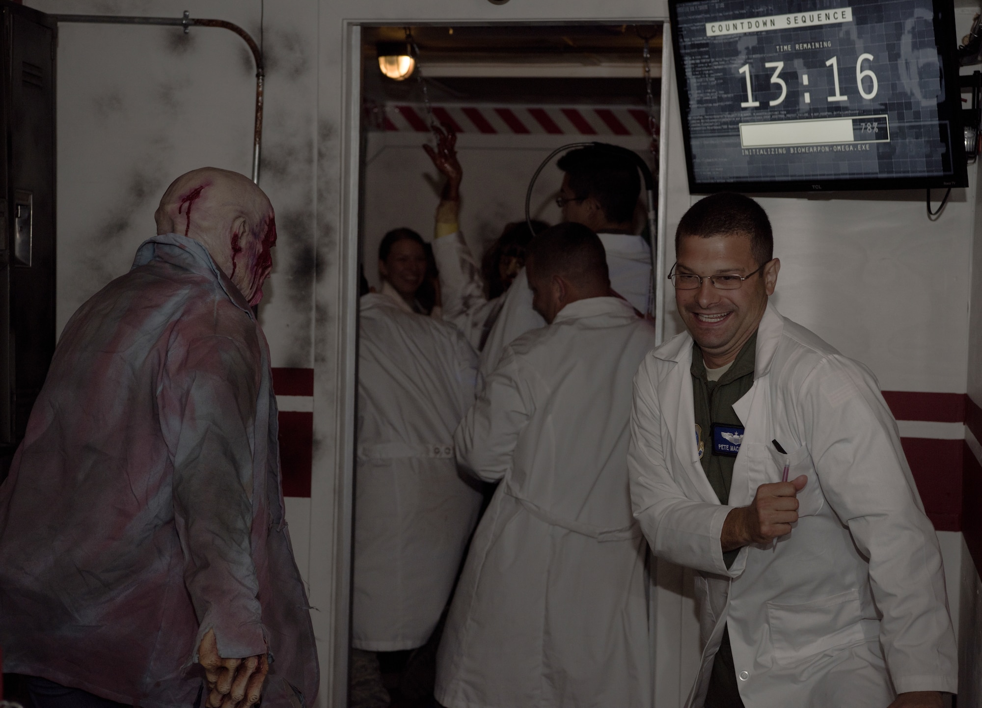 Airmen with the 6th Airlift Squadron run from a zombie during a session through a Mobile Escape Room on Joint Base McGuire-Dix-Lakehurst, N.J., Aug. 27, 2018. The zombie periodically attacked the players during their 30-minute sessions while they worked together to solve a puzzle in order to escape. (U.S. Air Force photo by Airman Ariel Owings)