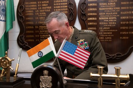 Marine Corps Gen. Joe Dunford, chairman of the Joint Chiefs of Staff, signs the guestbook of Indian Adm. Sunil Lanba, PVSM, AVSM, ADC, Indian Chief of the Naval Staff and Chairman of the chiefs of staff committee at the Ministry of Defence in New Delhi, India Sept. 6, 2018.