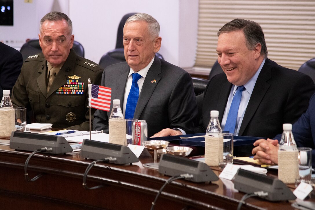 Three U.S. leaders sit next to each other at a meeting.