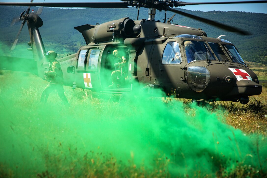 Marines prepare to load a mock casualty onto an Army helicopter during medical evacuation training.