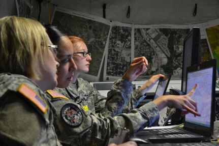 Capt. Jennifer Staton, a space operations officer, and Sgt. Cassandra Quinones and Pfc. Miranda Yost, geospatial engineers, use mapping software during the multi-state, large-scale, natural disaster emergency response exercise Vigilant Guard 2014, hosted by the Kansas National Guard in Salina, Kan., Aug. 4-7, 2014.