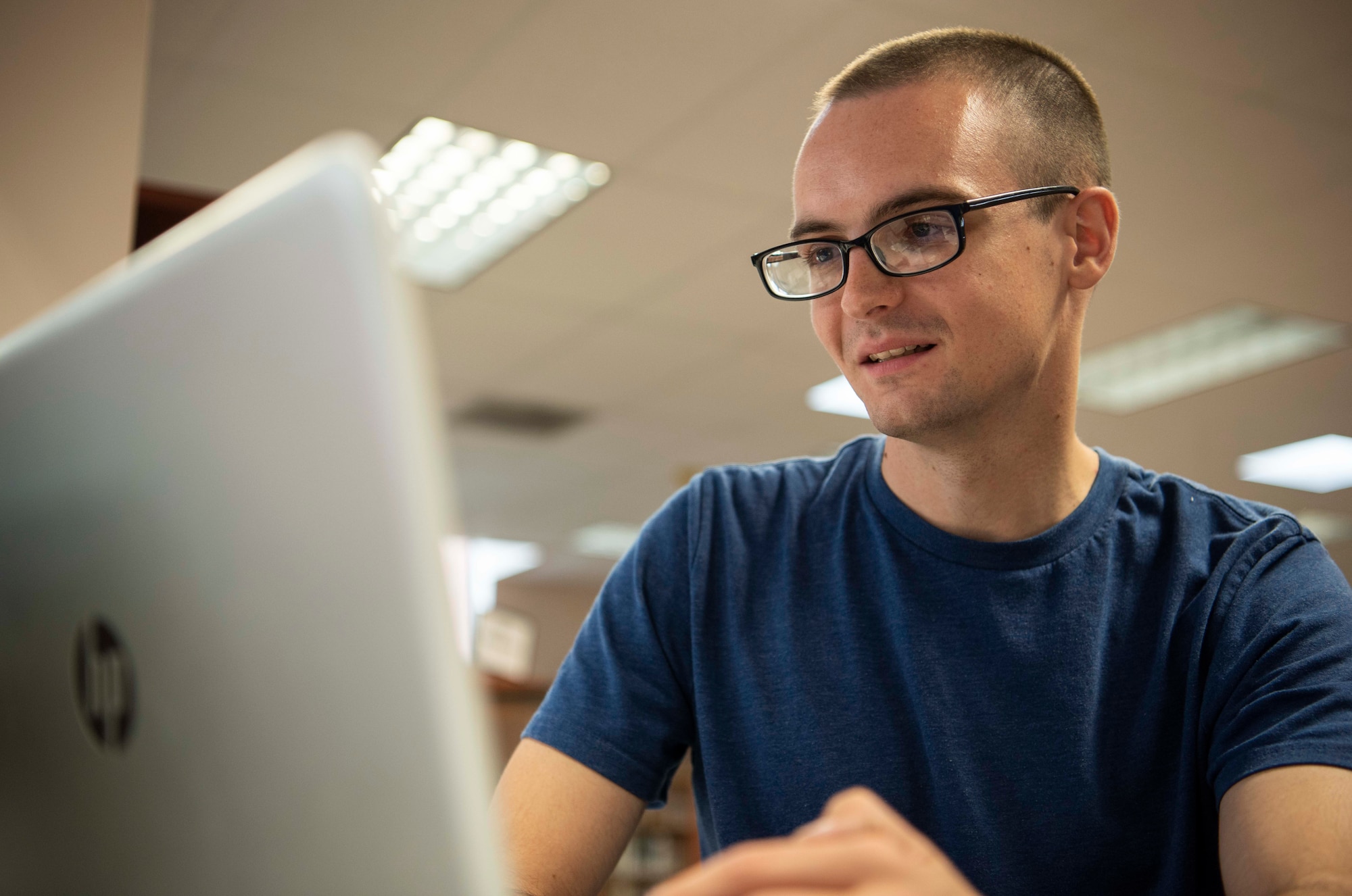 Staff Sgt. Christopher Povlich, 375th Communication Support Squadron mission defense operator, fixes a computer during Cyberfix, August 29, 2018, at the Scott Air Force Base Library, Scott AFB, Ill.