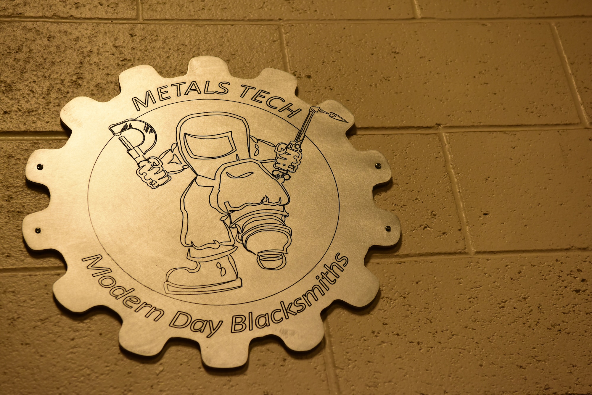 A metals tech sign adorns the 28th Maintenance Squadron metals technology shop at Ellsworth Air Force Base, S.D., Aug. 23, 2018. The metals technology shop runs 24-hour operations to provide different metals technologies for all squadrons on base. (U.S. Air Force photo by Airman John Ennis)