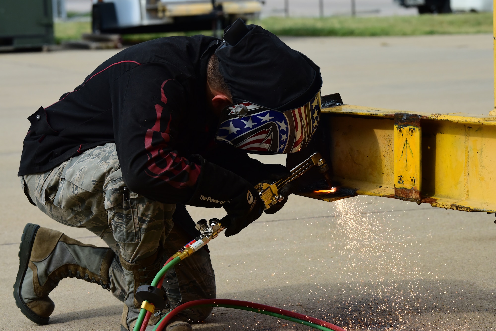 Senior Airman David Corona, a 28th Maintenance Squadron metals technician, cuts off a steel plate with an oxyacetylene torch at Ellsworth Air Force Base, S.D., Aug. 23, 2018. The metals technology shop runs 24-hour operations to provide different metals technologies for all squadrons on base. (U.S. Air Force photo by Airman John Ennis)
