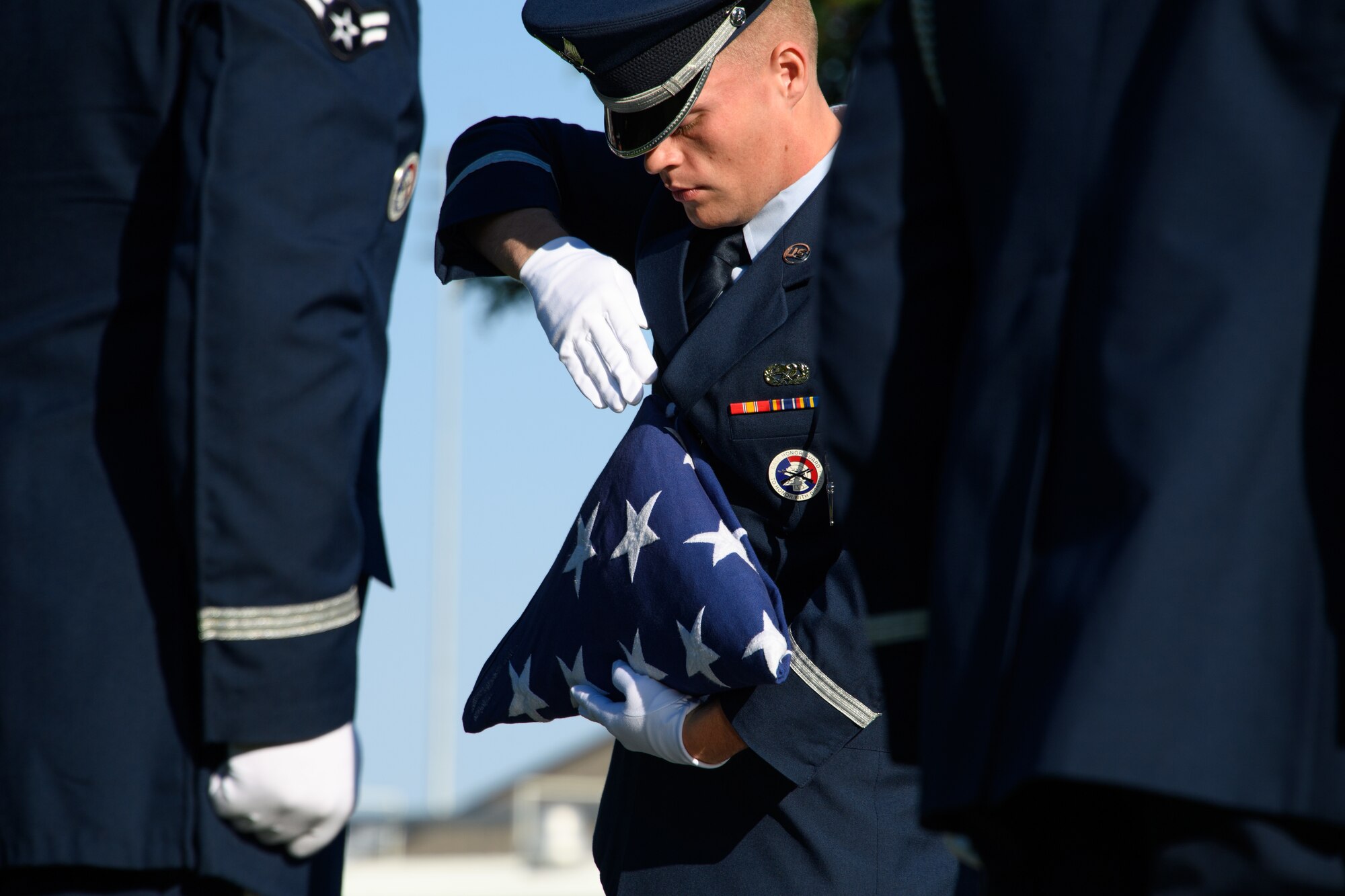 Senior Airman Ian Downs participates in a flag folding detail during an active-duty funeral service demonstration at Hill Air Force Base, Utah, Aug. 29, 2018. The demonstration was part of an honor guard graduation ceremony for 20 base honor guard Airmen. (U.S. Air Force photo by R. Nial Bradshaw)