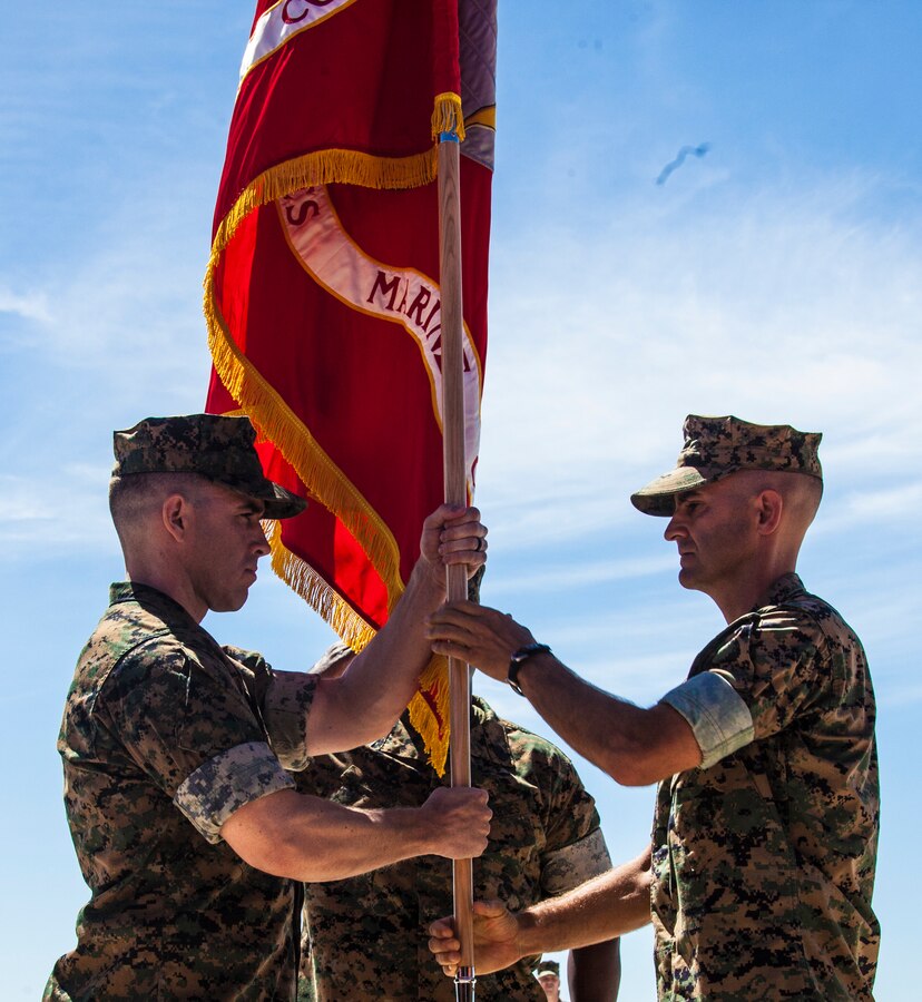Lt. Col. Allen J. Clarke, incoming commanding officer of Headquarters and Headquarters Squadron, receives the command's colors from Lt. Col. Michael A. Spears, outgoing commanding officer, during the change of command ceremony at Marine Corps Air Station Miramar, Calif., Aug. 30. The exchanging of the colors represented the transfer of responsibility, authority and accountability from Spears to Clarke. (U.S. Marine Corps photo by Cpl. Sarah Ralph)
