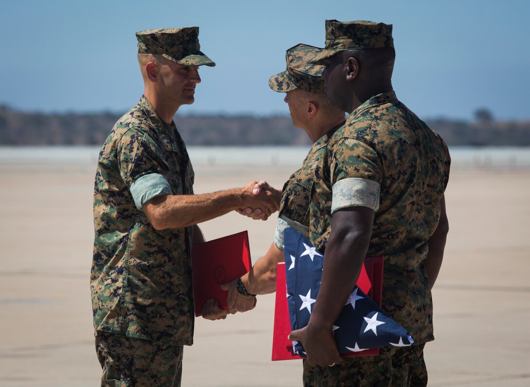 Lt. Col. Michael A. Spears, former commanding officer of Headquarters and Headquarters Squadron, receives awards and shakes hands with Col. Charles B. Dockery, commanding officer of Marine Corps Air Station Miramar, during the H&HS change of command and Lt. Col. Spears’s retirement ceremony at MCAS Miramar, Calif., Aug. 30. The ceremony officially recognized Spears for his 23 years of honorable service to the Marine Corps and his time as the commanding officer of H&HS from July 2016 through August 2018. (U.S. Marine Corps photo by Cpl. Becky Cleveland)