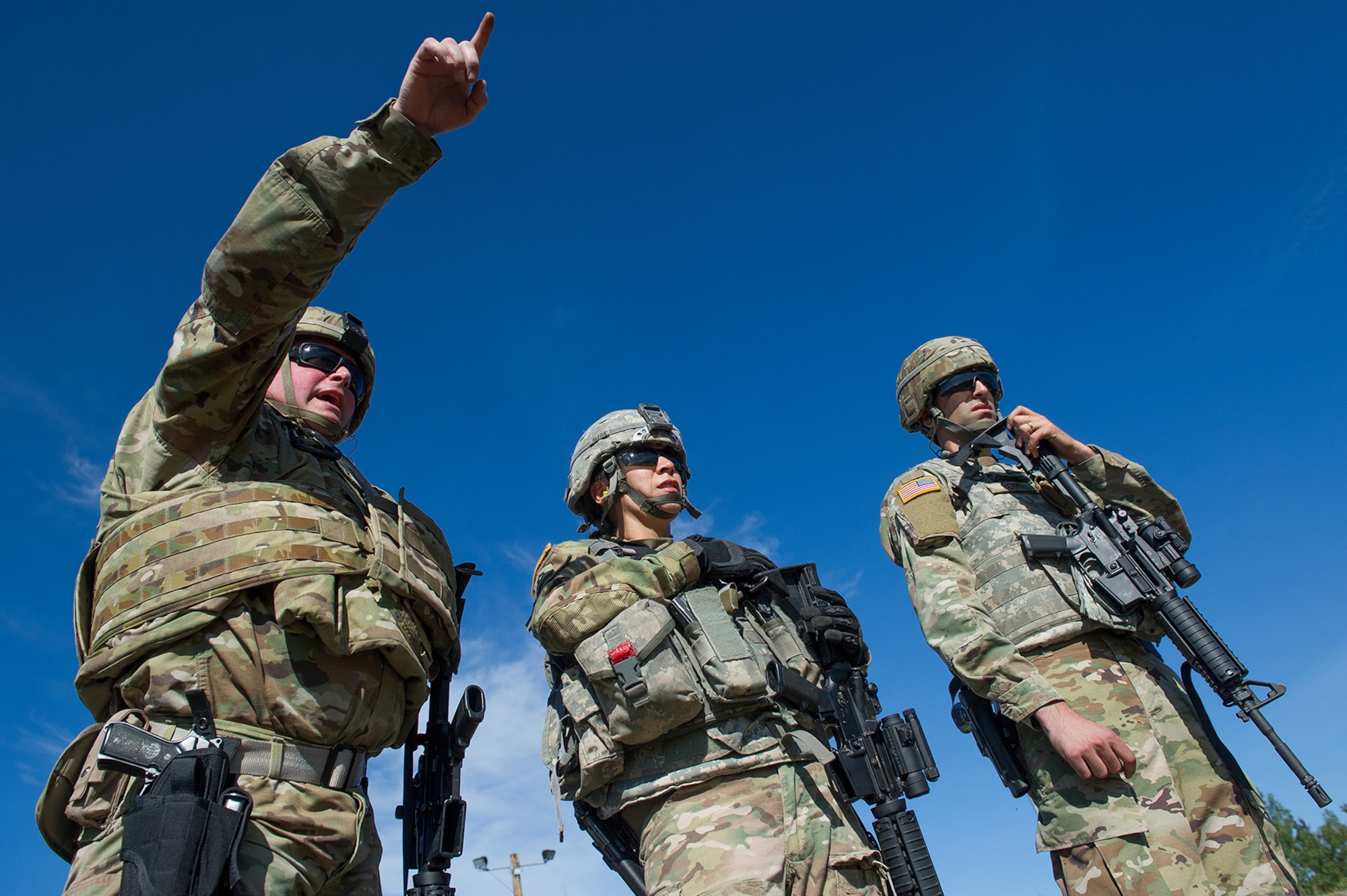 Army Sgt. Jason Varner, left, a native of Costa Mesa, Calif., points out targets to fellow Joint Base Lewis-McChord based Soldiers Army Staff Sgt. Daniell Garcia, a native of Rocky Ford, Colo., and Army Spc. Nicholas Riccio, a native of Charleston, Ill., during the first day of the America’s First Corps 2-Gun Sharpshooter Competition sponsored by U.S. Army Alaska's Sharpshooter Team at the Joint Base Elmendorf-Richardson, Alaska, Range Complex, Sept. 5, 2018.  Ten five-soldier teams assigned to multiple units throughout I Corps will compete in six stages of competition over two days with U.S. Army issued weapons for top sharpshooter honors.