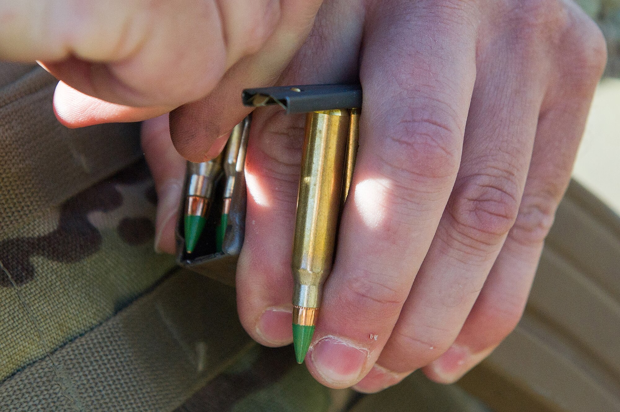 A soldier loads ammunition into a magazine while waiting to compete in the first day of the America’s First Corps 2-Gun Sharpshooter Competition sponsored by U.S. Army Alaska's Sharpshooter Team at the Joint Base Elmendorf-Richardson, Alaska, Range Complex, Sept. 5, 2018.  Two five-soldier teams assigned to units throughout I Corps will compete in six stages of competition over two days with U.S. Army issued weapons for top sharpshooter honors.