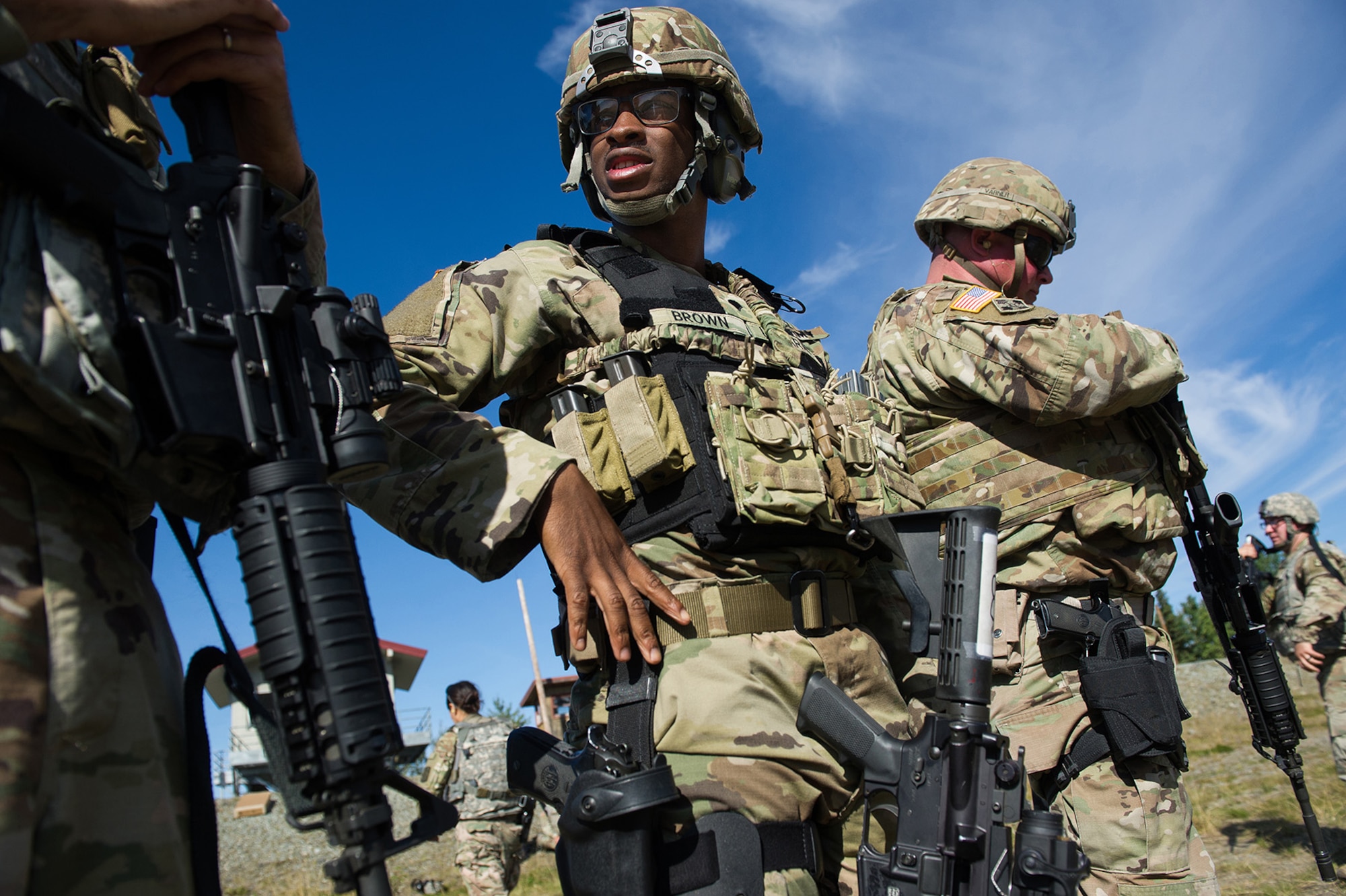 Army Spc. Antonio Brown, center, a native of Little Rock, Ark., assigned to the Joint Base Lewis-McChord based 13th Combat Support Sustainment Battalion, waits to compete in the first day of the America’s First Corps 2-Gun Sharpshooter Competition sponsored by U.S. Army Alaska's Sharpshooter Team at the Joint Base Elmendorf-Richardson, Alaska, Range Complex, Sept. 5, 2018.  Ten five-soldier teams assigned to multiple units throughout I Corps will compete in six stages of competition over two days with U.S. Army issued weapons for top sharpshooter honors.