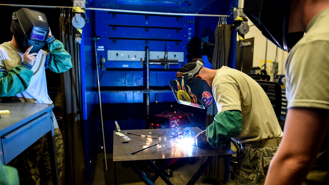 Metals Tech. instructor demonstrates welding to students.