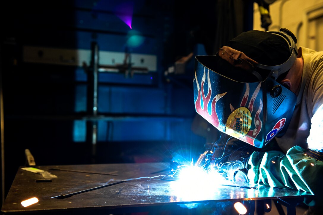 Metals Tech. instructor demonstrates welding to students.