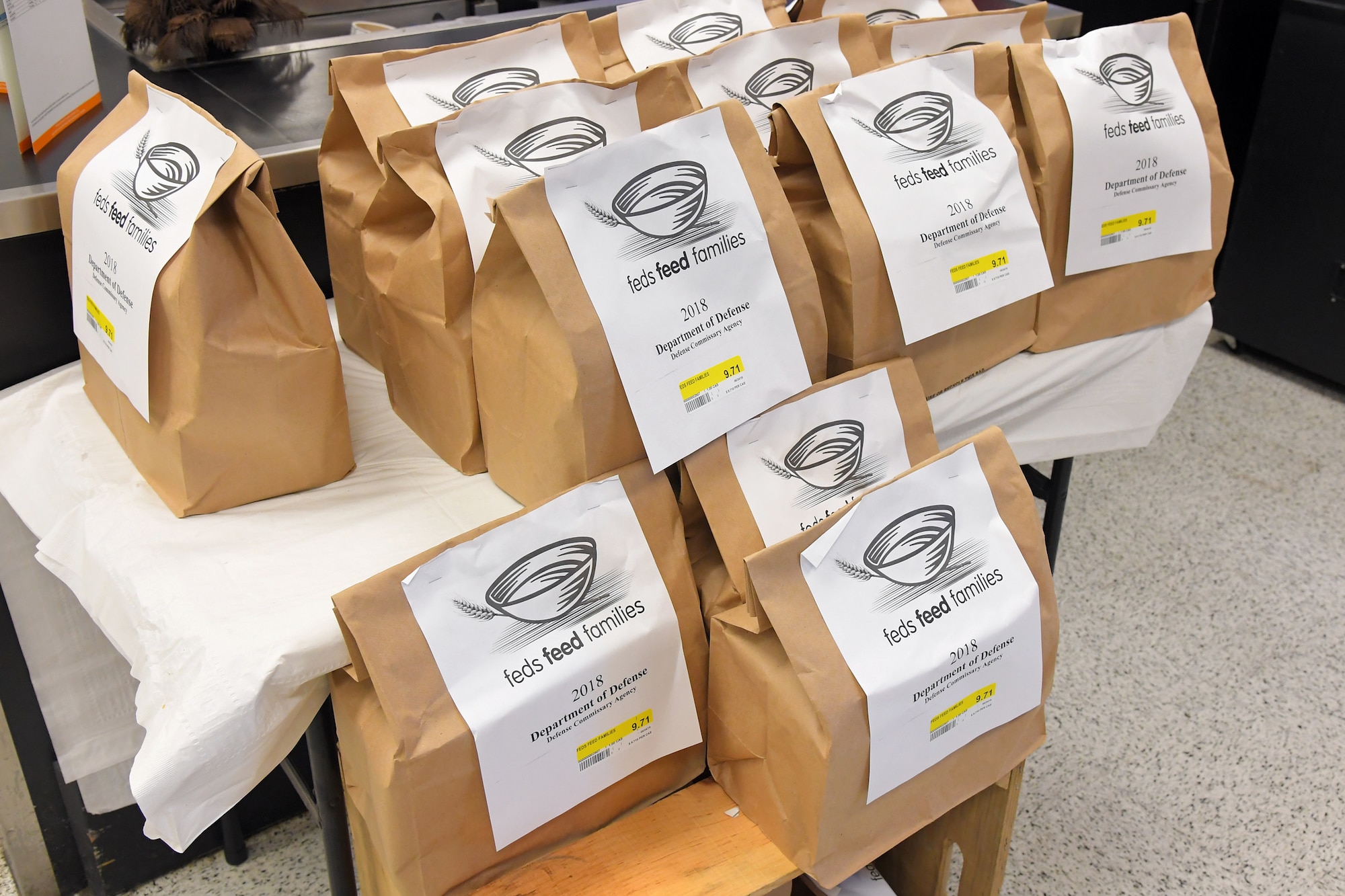 Pre-packaged bags of food are available for purchase by Hill Commissary customers as part of the 2018 Feds Feed Families campaign at Hill Air Force Base, Utah. During the campaign that began Aug. 10  and continues through Oct. 15, purchased bags of groceries will be donated to on- and off-base food pantries. (U.S. Air Force photo by Todd Cromar)