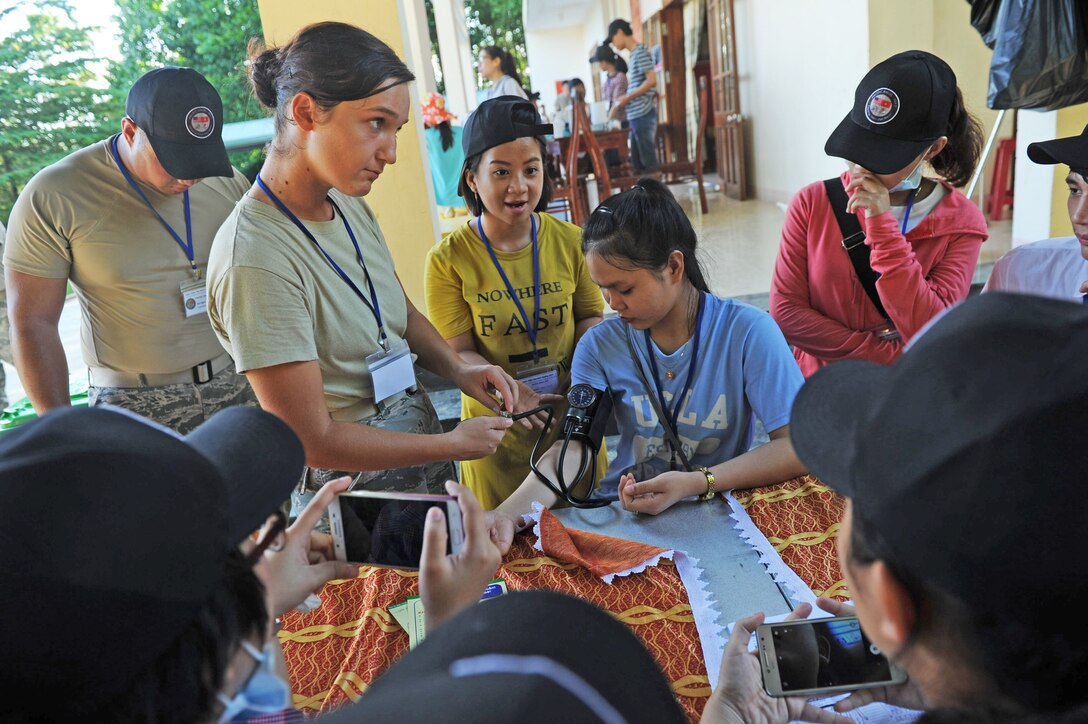 U.S. Air Force Senior Airman Arlinda Haliti, a medical technician, assigned to the 15th Medical Operations Squadron, Hickam Air Force Base, Hawaii, briefs Vietnamese nursing student volunteers on the proper procedures for taking blood pressure readings at a health services outreach site during Pacific Angel (PACANGEL) 17-2 in Tam Ky, Vietnam, Sept. 11, 2017