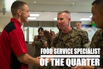 Lt. Gen. Eric Smith congratulates Pfc. Dominic Marimonti, for winning first place in the Food Specialist of the Quarter competition at Camp Kinser, Okinawa, Japan, Aug. 30, 2018. Smith is the commanding general of III Marine Expeditionary Force. Marimonti is a food service specialist with 3rd Marine Logistic Group Headquarters Regiment and is a native of St. Louis, Missouri. He competed in the competition to expand his culinary knowledge and test his abilities. (U.S. Marine Corps photo by Pfc. Kindo Go)