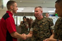 Lt. Gen. Eric Smith congratulates Pfc. Dominic Marimonti, for winning first place in the Food Specialist of the Quarter competition at Camp Kinser, Okinawa, Japan, Aug. 30, 2018. Smith is the commanding general of III Marine Expeditionary Force. Marimonti is a food service specialist with 3rd Marine Logistic Group Headquarters Regiment and is a native of St. Louis, Missouri. He competed in the competition to expand his culinary knowledge and test his abilities. (U.S. Marine Corps photo by Pfc. Kindo Go)