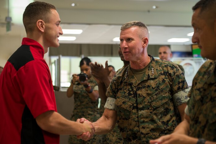 Lt. Gen. Eric Smith congratulates Pfc. Dominic Marimonti, for winning first place in the Food Specialist of the Quarter competition at Camp Kinser, Okinawa, Japan, Aug. 30, 2018. Smith is the commanding general of III Marine Expeditionary Force. Marimonti is a food service specialist with 3rd Marine Logistic Group Headquarters Regiment and is a native of St. Louis, Missouri. He competed in the competition to expand his culinary knowledge and test his abilities. (U.S. Marine Corps photo by Pfc. Kindo Go)