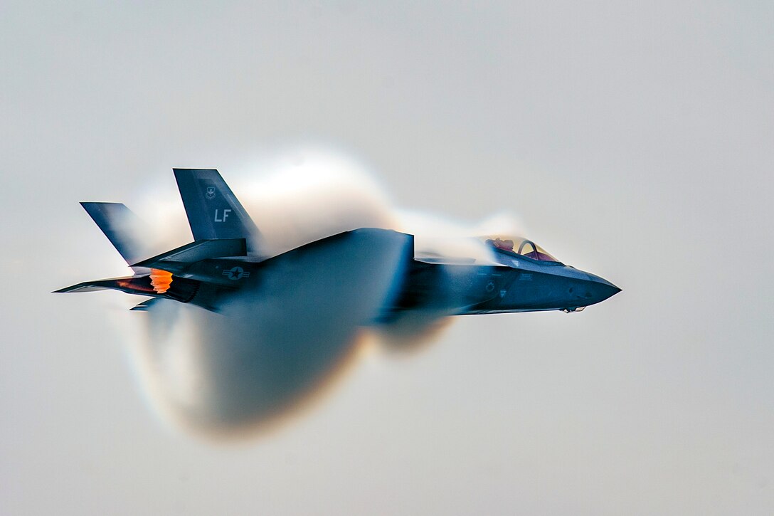 An f-35 flies through a cloud.