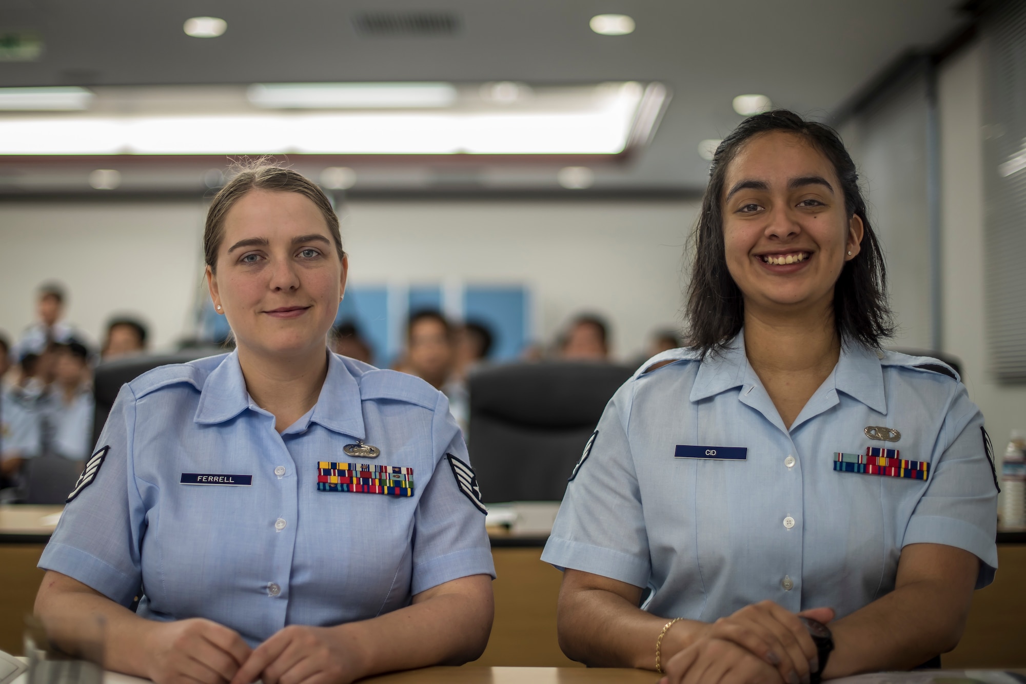 U.S. Air Force Staff Sgt. Kathryn Ferrell, left, a 35th Operations Support Squadron intel craftsman, and Senior Airman Grissel Cid, right, a 610th Air Control Flight weapons director technician, pause for a photo during the Japan Air Self-Defense Force English Competition at Misawa Air Base, Japan, Aug. 29, 2018. Approximately 35 members participated and each group prepared a whole performance in English for the judges. The enlisted personnel’s piece involved the rank structure and JASDF heritage. After each slideshow, the judges asked a question they developed from a certain slide. (U.S. Air Force photo by Airman 1st Class Xiomara M. Martinez)