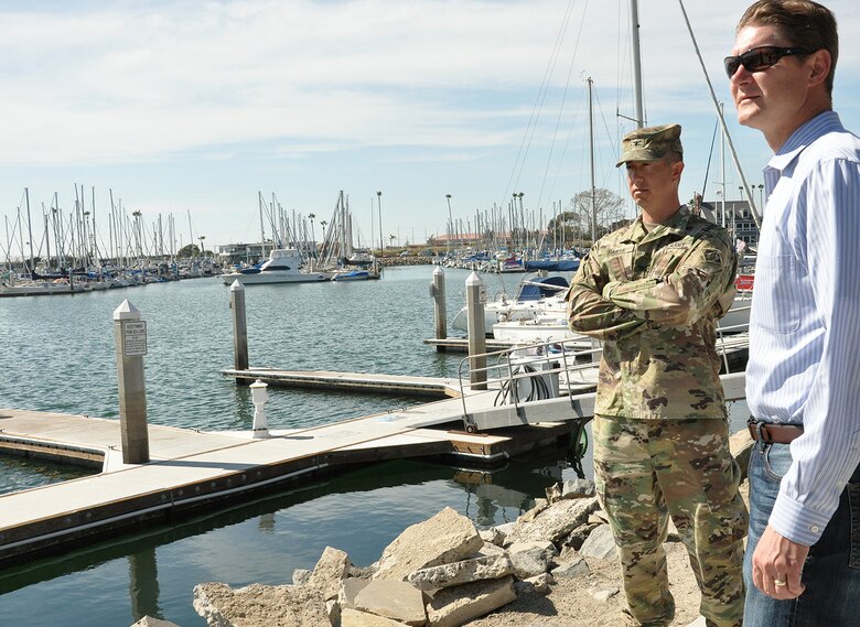 Col. Aaron Barta, U.S. Army Corps of Engineers Los Angeles District commander, left, and David Van Dorpe, deputy District engineer, LA District, right, look out over Oceanside Harbor following an Aug. 28 meeting with Oceanside city and harbor officials about the upcoming maintenance dredging of the entrance channel to the harbor, which is scheduled for October.