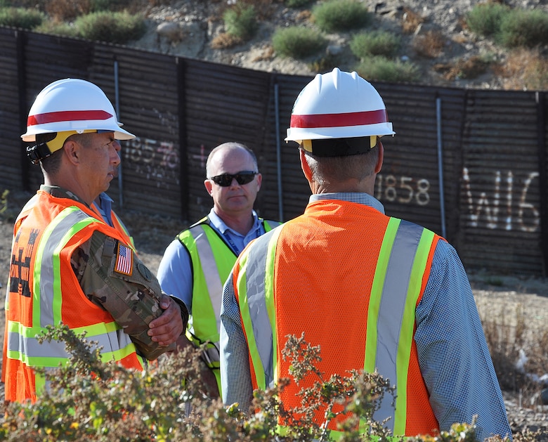 Col. Aaron Barta, U.S. Army Corps of Engineers Los Angeles District commander, left, is briefed about border infrastructure at the San Diego and Mexico International Border during an Aug. 30 project site visit in San Diego County, California.