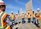 Col. Aaron Barta, U.S. Army Corps of Engineers Los Angeles District commander, far right, talks to Corps’ team members about the border infrastructure project in front of design prototypes near the San Diego and Mexico International Border during an Aug. 30 site visit in San Diego County, California.