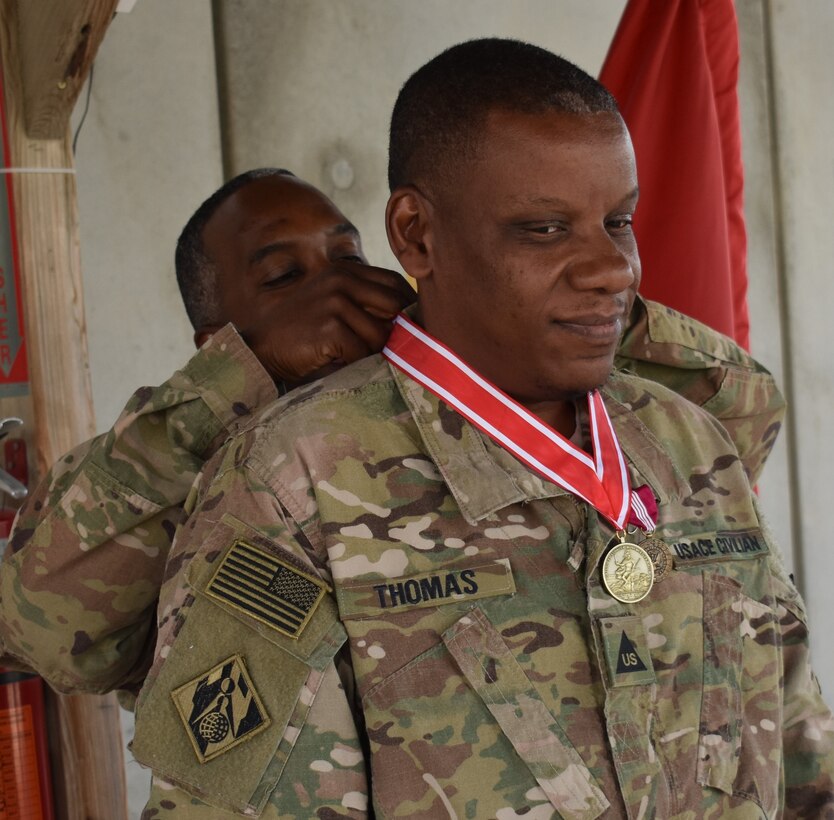 Col. Jason Kelly, Afghanistan District Commander presents to Lawrence W. Thomas from the Army Engineer Association on behalf of the Engineer Regiment the Bronze order of the DeFleury Medal. His citation read in part, “In recognition of superior service to the United States Army Engineer Regiment as it supports the Army to assure mobility, enhance protection, enable expeditionary logistics, and build capacity in order to provide commanders with the freedom of action required for full spectrum operations in an era of persistent conflict.” Signed Todd T. Semonite, Lieutenant General, U. S. Army Chief of Engineers.