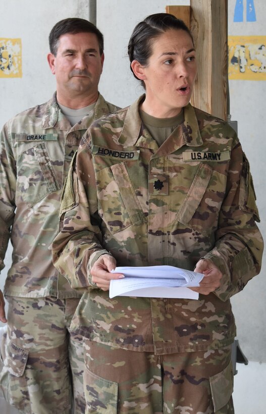 Lieutenant Col. Rachel Honderd, Afghanistan District Deputy Commander reads the history of the DeFleury Medal, as John Drake, Deputy District Engineer for Programs and Project Management Division looks on. The de Fleury medal was named in honor of Francois de Fleury, a French Engineer in the Continental Army.