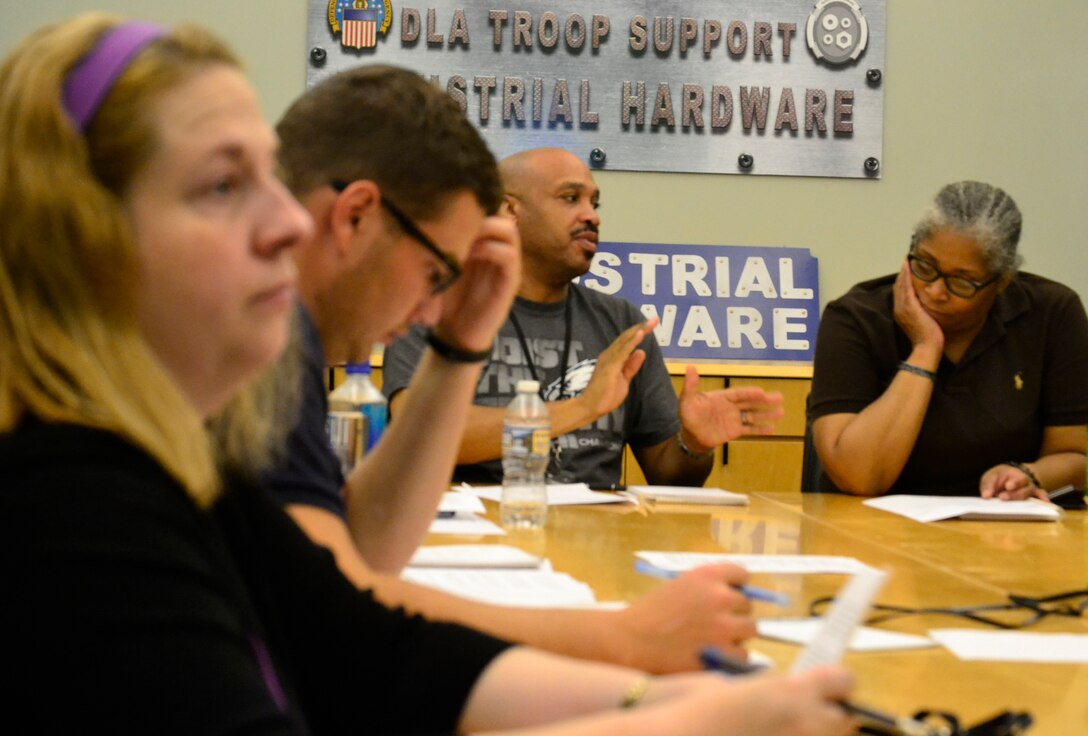 DLA Troop Support employees follow along as a team of Industrial Hardware acquisition professionals help prepare them for acquisition training they will attend in the coming months.