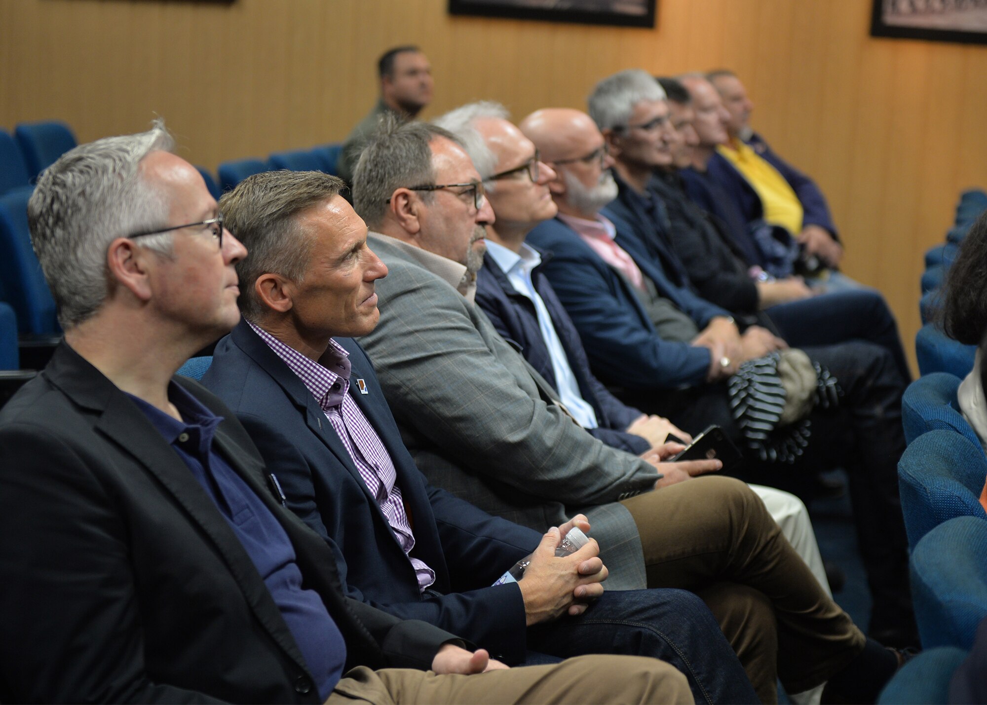 Host nation civic leaders listen to a pre-flight briefing at the 37th Airlift Squadron on Ramstein Air Base, Germany, Aug. 31, 2018. During the briefing, the visitors were informed of the flight route and points of interest during the flight
