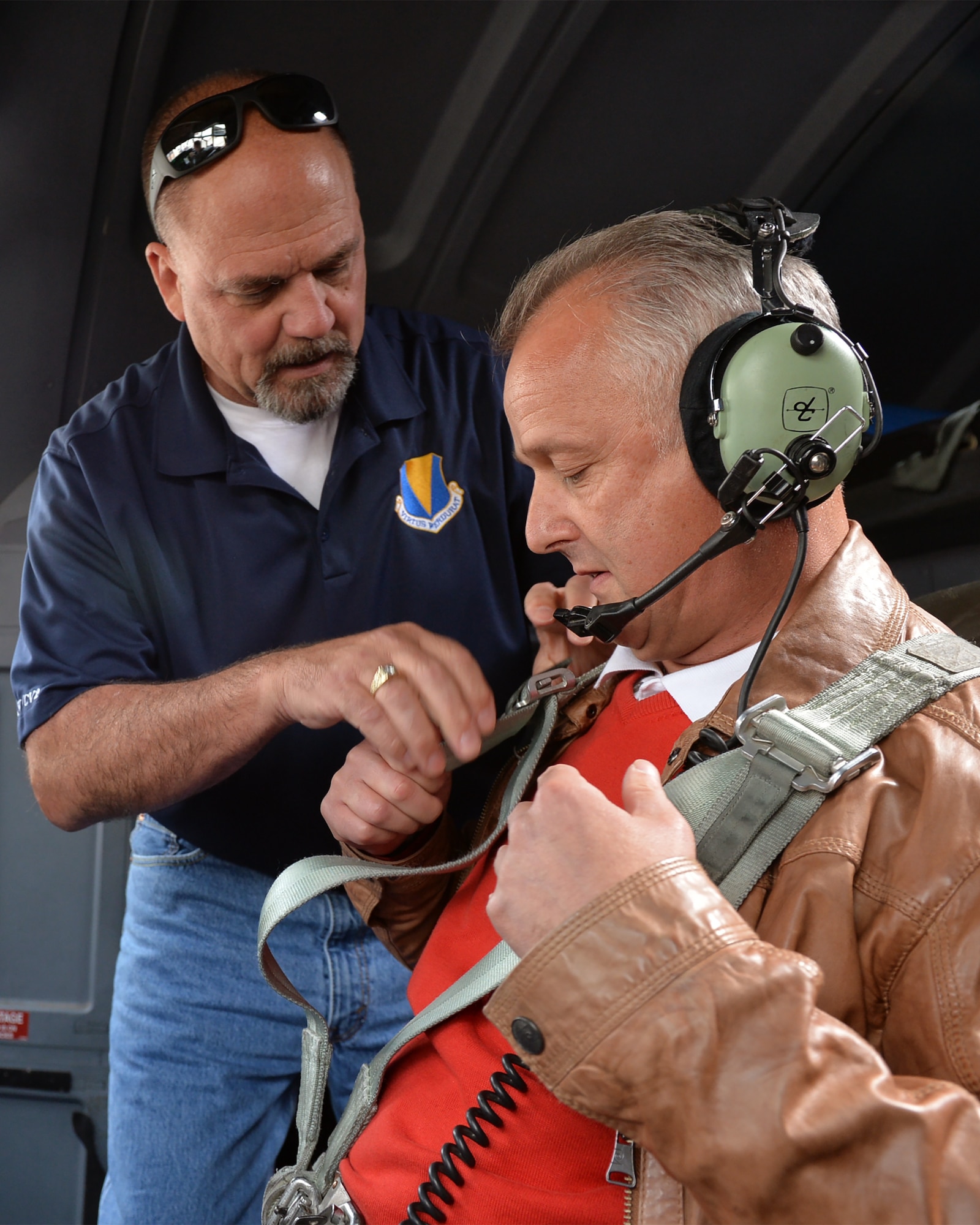 Scott C. Lockard, 86th Airlift Wing vice director, assists Markus Vollmer, a local civic leader, with a C-130J Super Hercules seatbelt on Ramstein Air Base, Germany, Aug. 31, 2018. Host nation civic leaders and their spouses were invited to tour the base and learn about Ramstein’s missions.