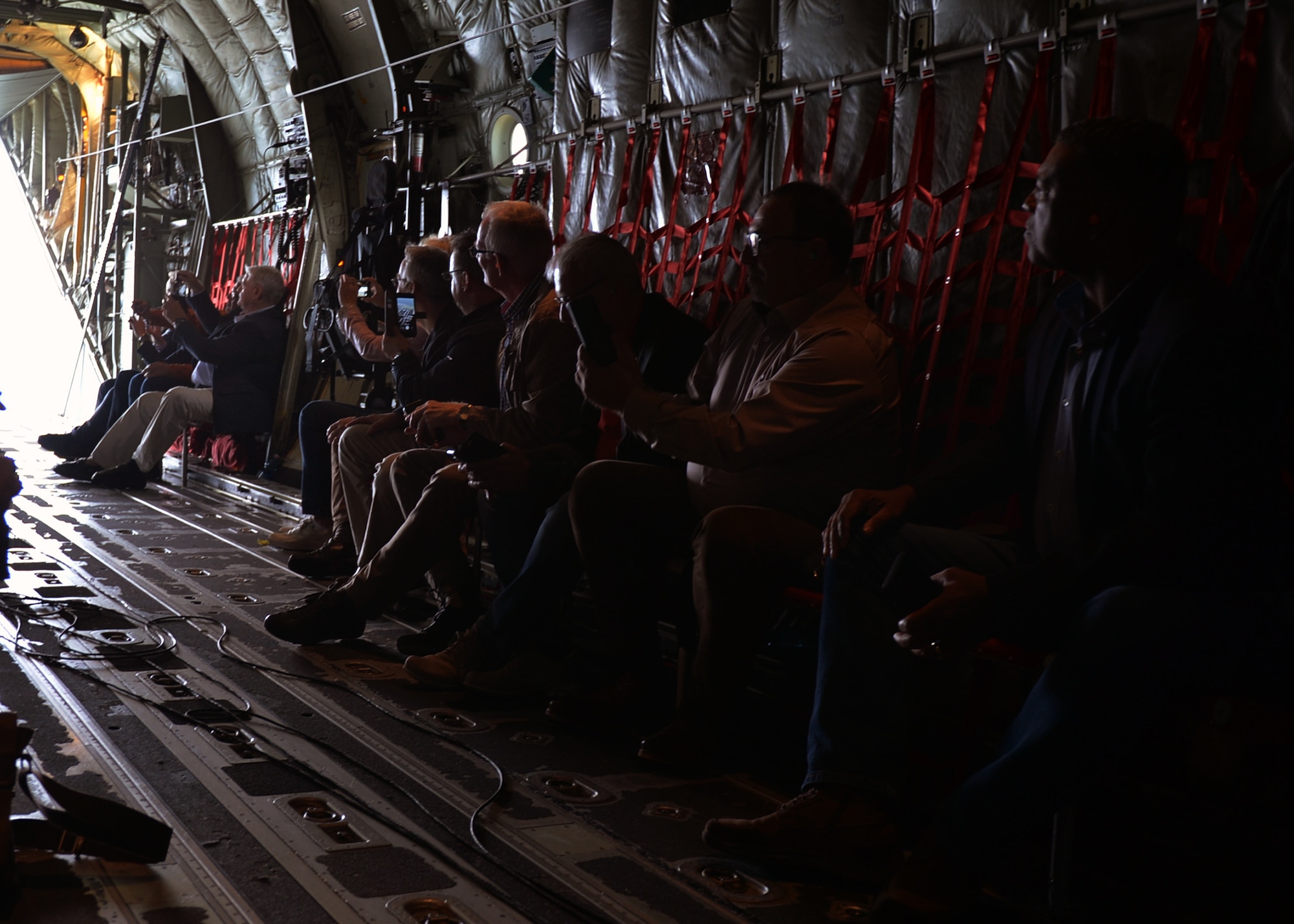 Local German civic leaders take photos of German landscapes from the back of a C-130J Super Hercules during an orientation flight from Ramstein Air Base, Germany, Aug. 31, 2018. The flight was given as a token of appreciation to host nation civic leaders for their continued support of the U.S. Air Force mission in Germany.