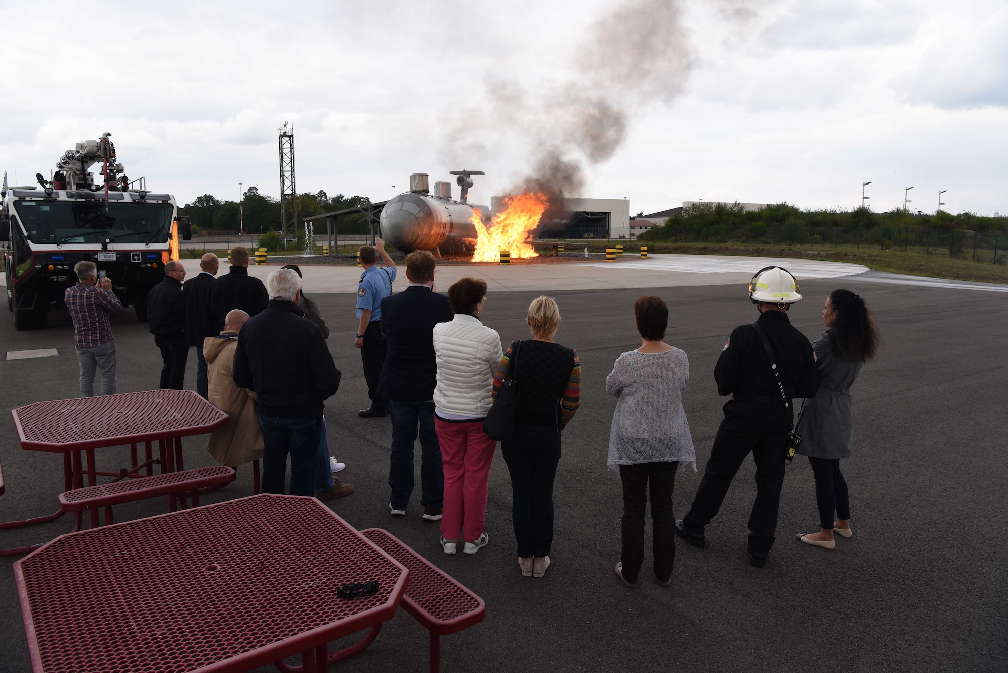 Host nation distinguished visitors watch a controlled fire on Ramstein Air Base, Germany, Aug. 31, 2018 .The last stop of the base tour allowed German civic leaders to watch Ramstein firefighters train to extinguish aircraft fires.