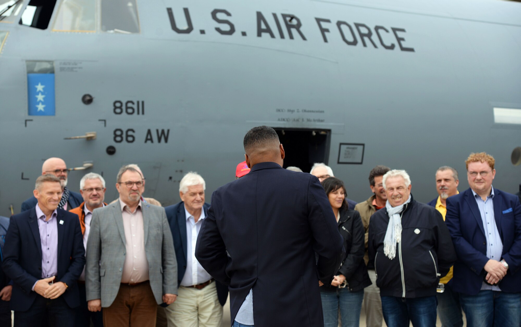 Local German civic leaders and U.S. Air Force service members pose for a group photo with a C-130J Super Hercules on Ramstein Air Base, Germany, Aug. 31, 2018.  The orientation flight was a way for Team Ramstein to show appreciation for their continued support of Ramstein.
