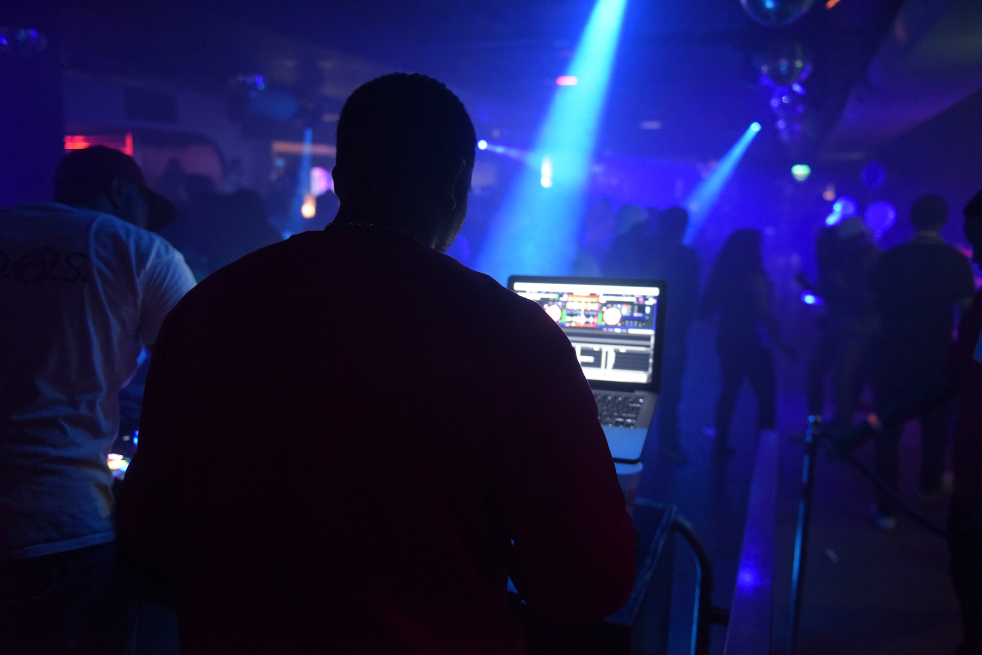 U.S. Air Force Staff Sgt. Elijah Rasheed, 100th Logistics Readiness Squadron aircraft parts store supervisor, mixes music for his disc jockey set at a local club in Cambridge, England, Sept. 2, 2018. Rasheed learned how to be a disc jockey three years ago and performs not only at local clubs but at LRS squadron picnics and events as well. (U.S. Air Force photo by Airman 1st Class Alexandria Lee)