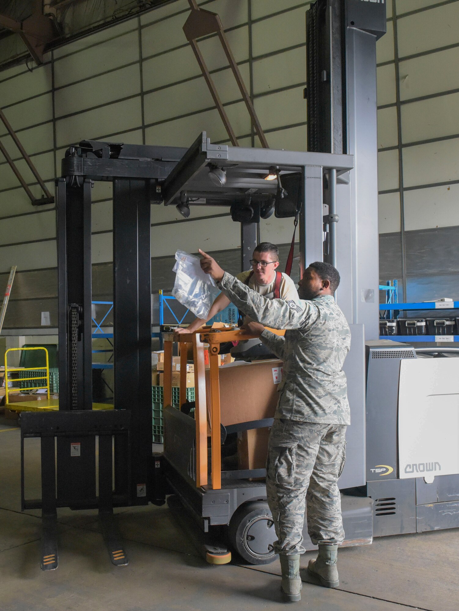 U.S. Air Force Airman 1st Class Hayden Theel, 100th Logistics Readiness Squadron aircraft parts store journeyman, and Staff Sgt. Elijah Rasheed, 100th LRS APS supervisor, locate an aircraft part to be placed in the proper location in a warehouse at RAF Mildenhall, England, Sept. 4, 2018. With all of the energy and time ‘DJ Messiah’, also known as Staff Sgt. Rasheed, puts into his part-time job as a disc jockey, he never lets it interfere with him being a full-time non-commissioned officer. (U.S. Air Force photo by Airman 1st Class Alexandria Lee)