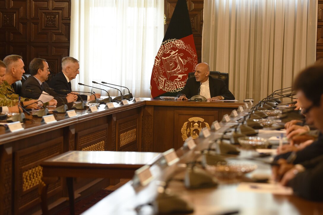 Defense Secretary James N. Mattis meets with at a table with the Afghan president and others.