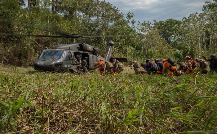 The Colombian civil defense team, firefighters and Peruvian Airmen load triage patients onto a Colombian UH-60 Blackhawk during exercise Angel de los Andes Sept. 5, 2018 at German Olano Air Base, Colombia. Angel de los Andes is a search and rescue exercise hosted by Colombia involving 12 partner nations that will work together in a joint environment and focus on exercising search and rescue, aeromedical evacuation and casualty evacuation operations. (U.S. Air Force photo by Staff Sgt. Robert Hicks)
