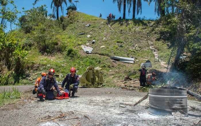 The Colombian civil defense team and firefighters prepare to lift a triage patient after a simulated aircraft crash during exercise Angel de los Andes Sept. 5, 2018 at German Olano Air Base, Colombia. Airmen from Colombia, Peru, Brazil and the United States worked with Colombian firefighters and civil defense team to air evacuate more than 25 people during a simulated aircraft crash. (U.S. Air Force photo by Staff Sgt. Robert Hicks)