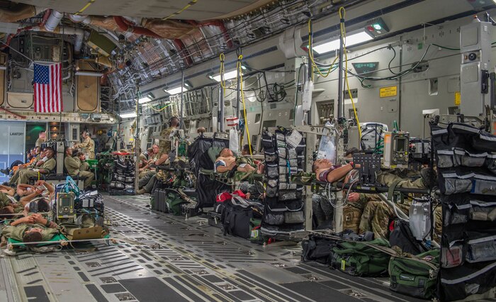 Triage patients wait to be air evacuated on a C-17 Globemaster III from Charleston Air Force Base, South Carolina, during a simulation as part of the multilateral exercise Angel de los Andes Sept. 5, 2018 at German Olano Air Base, Colombia. Airmen from Colombia, Peru, Brazil and the United States worked with Colombian firefighters and civil defense team to air evacuate more than 25 people during a simulated aircraft crash. (U.S. Air Force photo by Staff Sgt. Robert Hicks)
