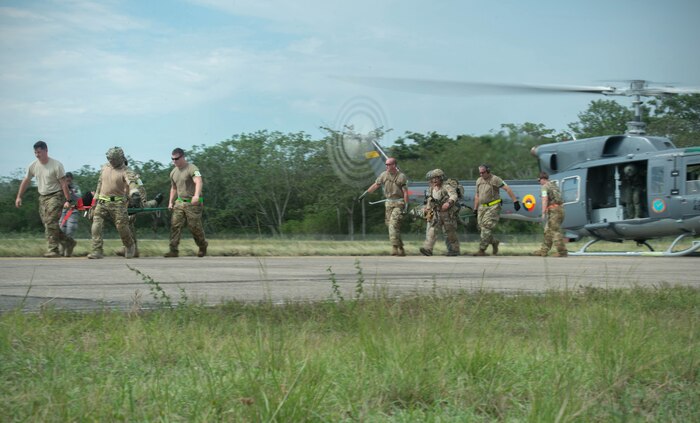 Airmen from the U.S. Air Force simulate offloading triage patients from a Colombian helicopter during exercise Angel de los Andes Sept. 5, 2018 at German Olano Air Base, Colombia. Angel de los Andes is a search and rescue exercise hosted by Colombia involving 12 partner nations that will work together in a joint environment and focus on exercising search and rescue, aeromedical evacuation and casualty evacuation operations. (U.S. Air Force photo by Staff Sgt. Robert Hicks)