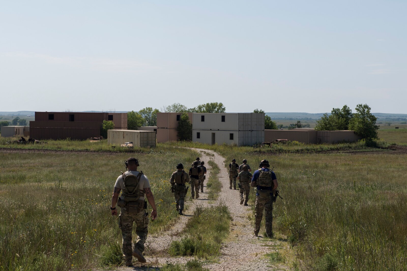 Students trek into a simulated village during a full spectrum operator course, Aug. 29, 2018, at Smoky Hill Air National Guard Range, Kan. The course was held Aug. 26-31, and incorporated specific duties performed by tactical air control party members and security forces personnel to build on their gunfighting skills. (U.S. Air Force photo by Senior Airman Janiqua P. Robinson)