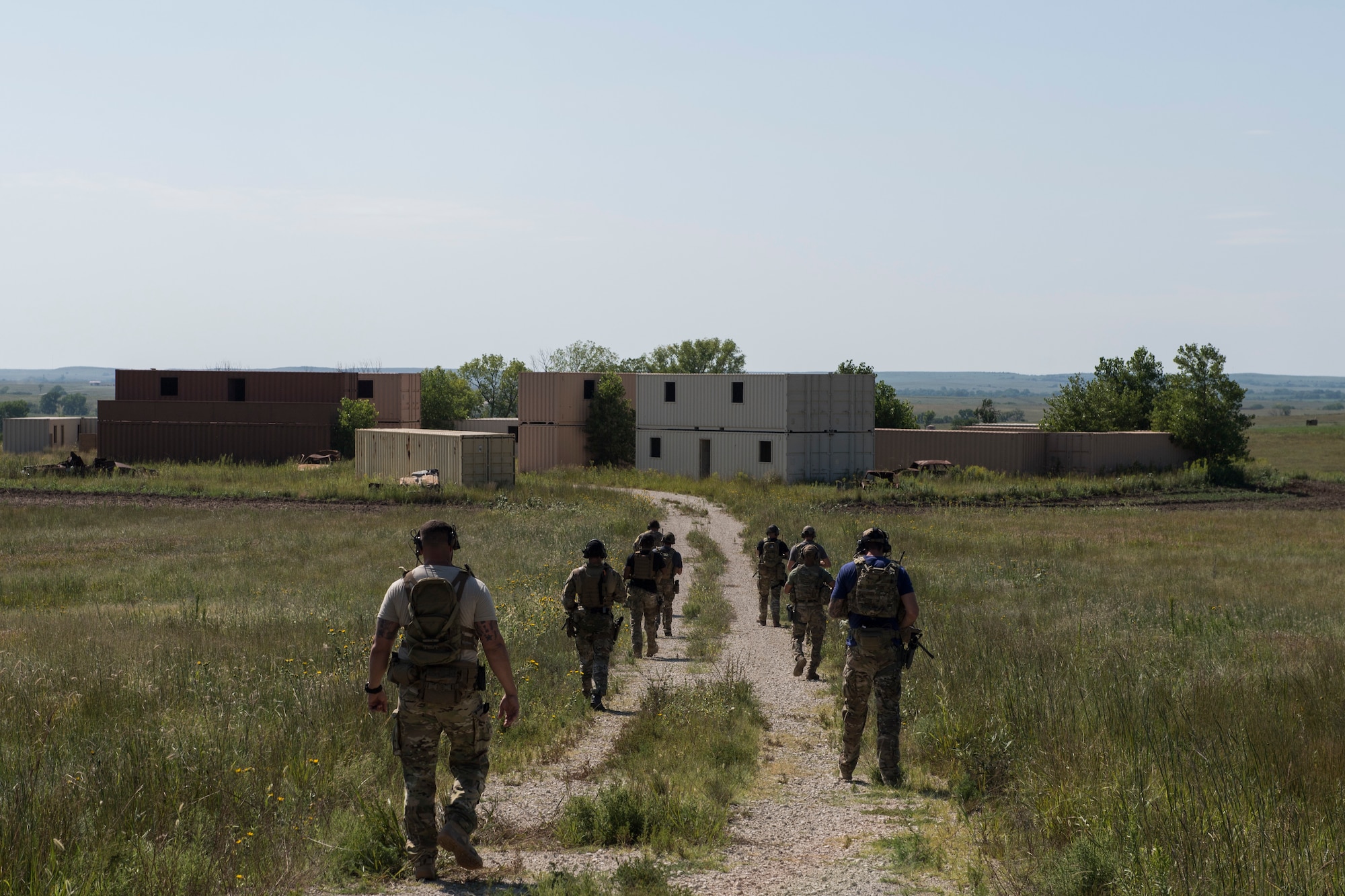 Students trek into a simulated village during a full spectrum operator course, Aug. 29, 2018, at Smoky Hill Air National Guard Range, Kan. The course was held Aug. 26-31, and incorporated specific duties performed by tactical air control party members and security forces personnel to build on their gunfighting skills. (U.S. Air Force photo by Senior Airman Janiqua P. Robinson)