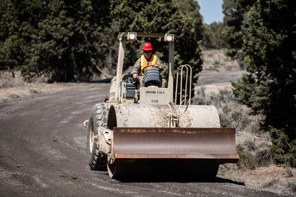 An Oregon Army National Guard Soldier with the 224th Engineer Company, 1249th Engineer Battalion, smooths out a freshly resurfaced road at Biak Training Center near Redmond, Oregon, June 19, 2018. The 224th Engineer Co. spent their 2018 annual training repairing and resurfacing several miles of gravel road on the 43,000 acres at Biak, which is open to both military training and public recreational use.