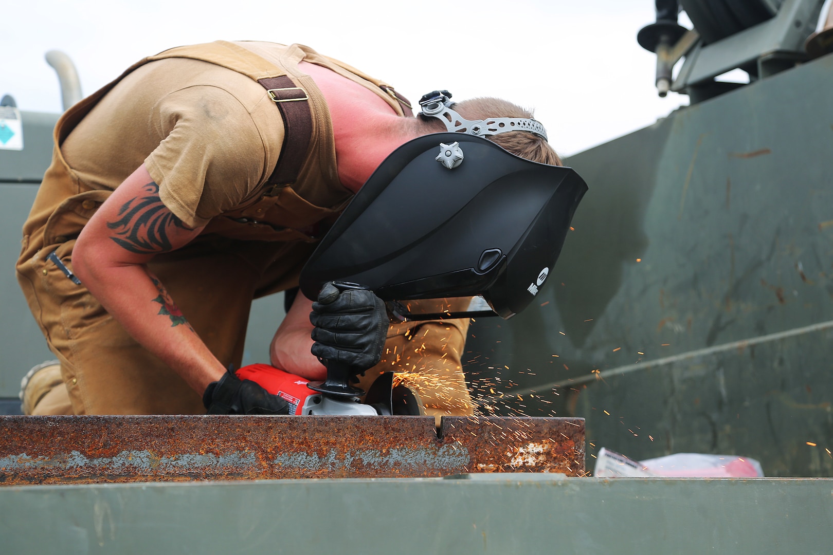 A U.S. Navy Steelworker cuts metal during water well drilling exploration site set up in Riohacha, Colombia.
