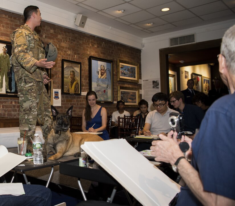 U.S Air Force Staff Sgt. Eric Shenton, 87th Security Forces Squadron military working dog handler, pose with his K-9 Kkrusty during a sketch night at the Society of Illustrators Museum in New York, Aug. 30, 2018. Shenton talked about Kkrusty’s military service since the last time he posed for sketch night.