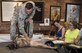 U.S. Air Force Staff Sgt. Tyler Hopkins, 87th Security Forces Squadron military working dog handler, pets his K-9 Kira during a sketch night at the Society of Illustrators Museum in New York, Aug. 30, 2018. Hopkins spoke about Kira’s deployment and how she lost a toe on her front paw.